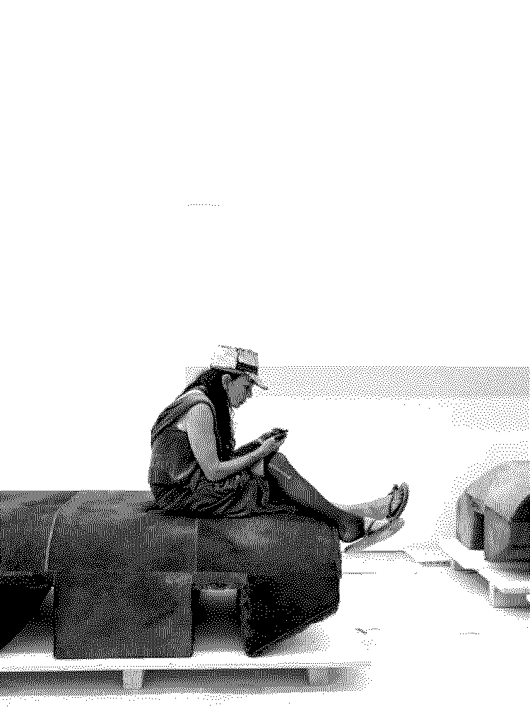 Person sitting on a low bench, black and white